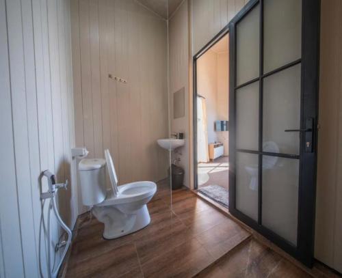 a bathroom with a toilet and a sink at Beji Bedugul Glamping in Bedugul