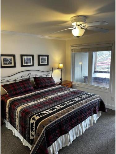 a bedroom with a bed and a ceiling fan at River & Vine in Helen
