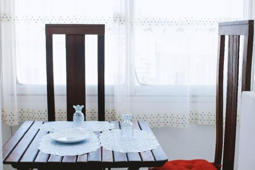 a wooden table with a plate on top of it at Appartement VIP centre ville in Toamasina