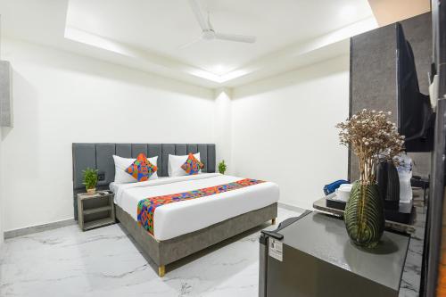 a bedroom with a king sized bed and a desk at FabHotel The Silken Stay in Gurgaon