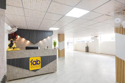 an office lobby with a ibid hotel sign on the wall at FabHotel The Silken Stay in Gurgaon