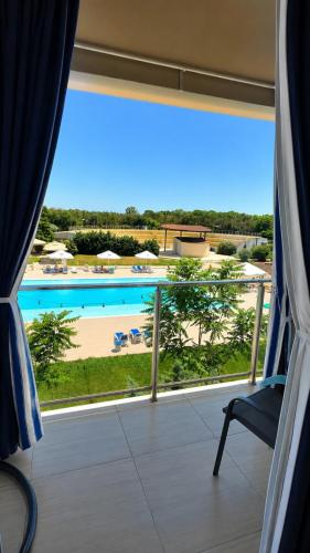 a room with a window with a view of a pool at Zen Studio Olimp Poolside in Olimp