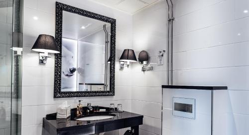 a bathroom with a sink and a mirror at Arctic Light Hotel in Rovaniemi