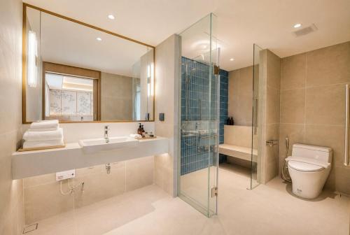 a bathroom with a toilet and a sink and a shower at Myneris Hotel, Phuket Karon Beach in Karon Beach