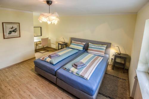 a bedroom with a blue bed with two pillows at Ferienwohnung Habermehl in Oppenau
