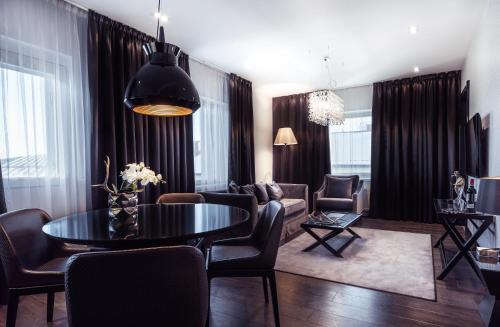 a living room with a table and chairs at Arctic Light Hotel in Rovaniemi
