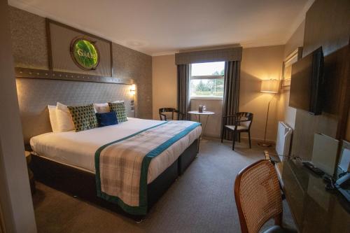 a hotel room with a bed and a window at The Gailes Hotel & Spa in Irvine