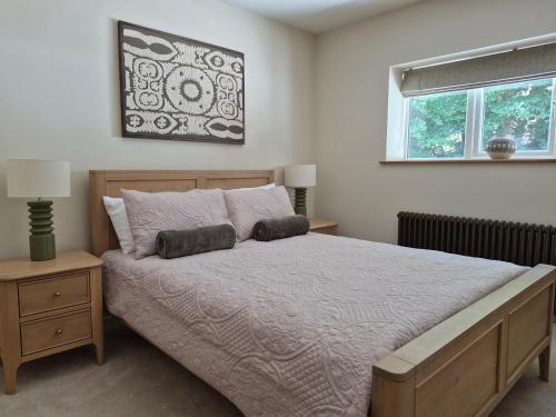 a bedroom with a large bed and a window at Thorn Tree Cottage in Hope