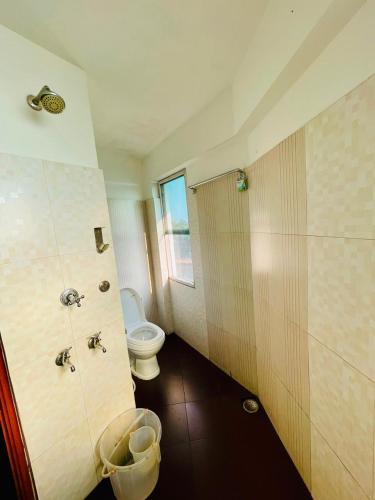 a bathroom with a toilet and a shower and a sink at Oval Retreat in Cochin