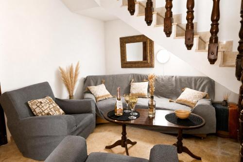 a living room with two couches and a table at Sefranda Guesthouse in San Ġwann