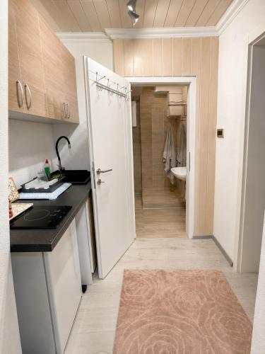 a kitchen with a door open to a bathroom at KOTA - Prime Location in Jahorina