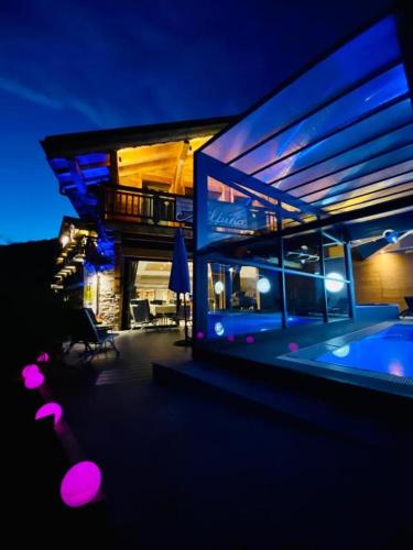 a house with a swimming pool in front of it at Hotel Alpina in Morzine