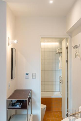 a bathroom with a toilet and a sink and a shower at Monday Mansion Hotel in Seoul