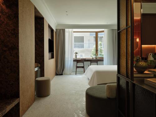 a hotel room with a bed and a table at The Newel Kolonaki in Athens