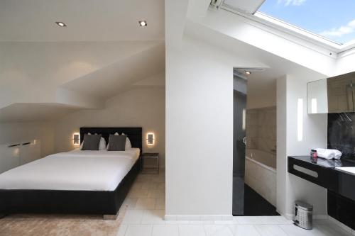 a bedroom with a large bed and a kitchen at VISIONAPARTMENTS Freyastrasse - self check-in in Zurich