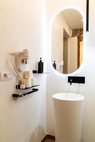 a bathroom with a white sink and a mirror at Turin Central Suite in Turin