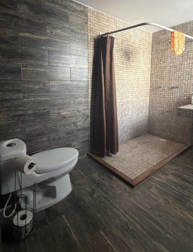 a bathroom with a toilet and a shower at Sol de México in Isla Mujeres