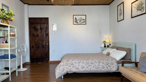 a bedroom with a bed and a couch at Vanilla Homestay Da Lat in Da Lat