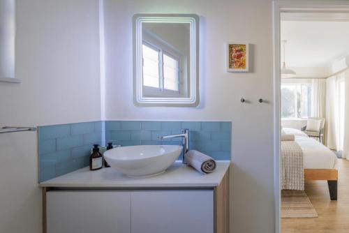a bathroom with a sink and a mirror at Elegant Seaview Suite 1 in Swakopmund