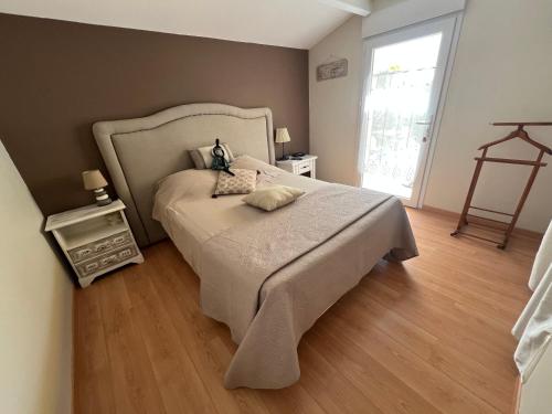 a bedroom with a large bed and a window at Le temps d une escapade vendéenne in Saint-Gervais