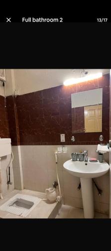a bathroom with a sink and a toilet at CH guest house in Murree