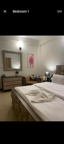 a bedroom with two beds and a living room at CH guest house in Murree