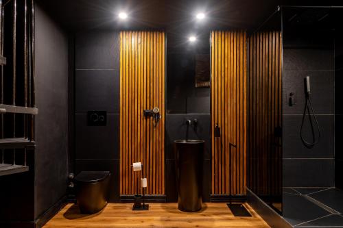 a bathroom with a toilet and a shower with yellow stripes at Turin Central Cavour in Turin