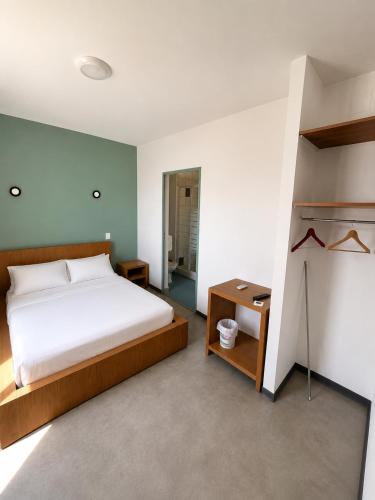 a bedroom with a bed and a night stand and a desk at Hôtel 2 Étoiles centre ville in Mont-de-Marsan
