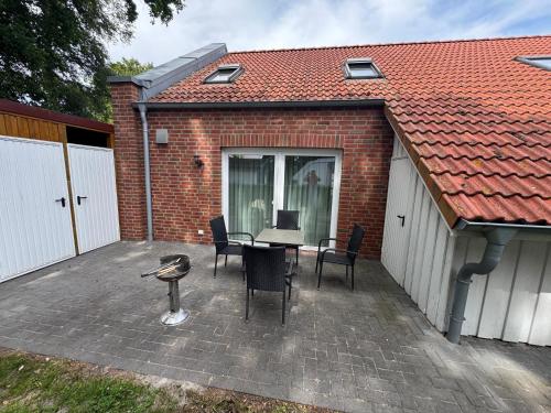 a patio with a table and chairs and a building at Loft Hesel, 35232 in Hesel