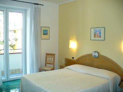 Säng eller sängar i ett rum på Hotel La Marticana