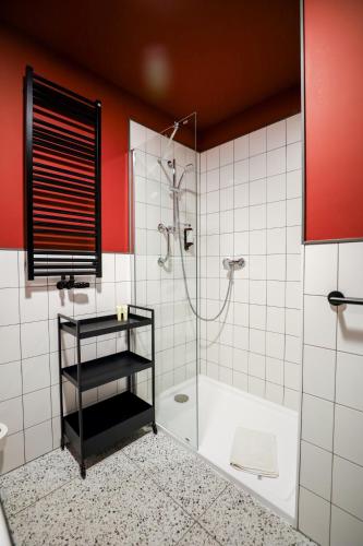 a bathroom with a shower with a glass door at Arche Hotel Piła in Piła