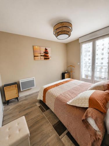 a bedroom with a large bed and a television at LE TOURISTIC Appartements T2 et T3 in Luz-Saint-Sauveur