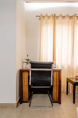 a black chair sitting in front of a desk at Royal Residency 610 Golf View in Gurgaon