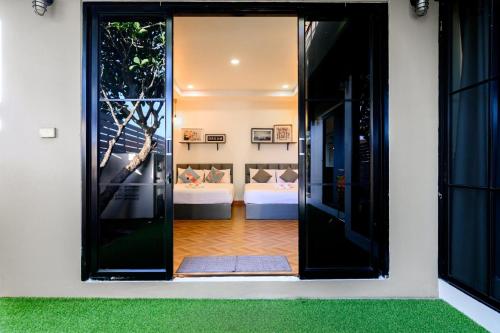 an open door to a bedroom with a view of a room at Modern Spacious 3-bed Ban Amphur Pool Villa (BA1) in Na Jomtien