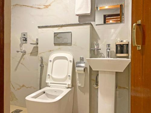 a bathroom with a toilet and a sink at Shine Boutique Hotel in Kathmandu