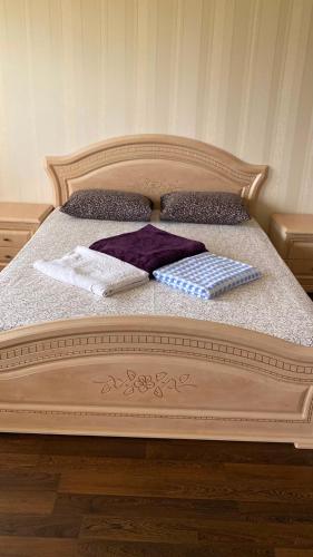 a bed with two towels and pillows on it at Дом на берегу Черного Моря in Zatoka