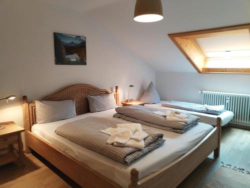 a bedroom with two beds with towels on them at Haus Obermaiselstein in Obermaiselstein