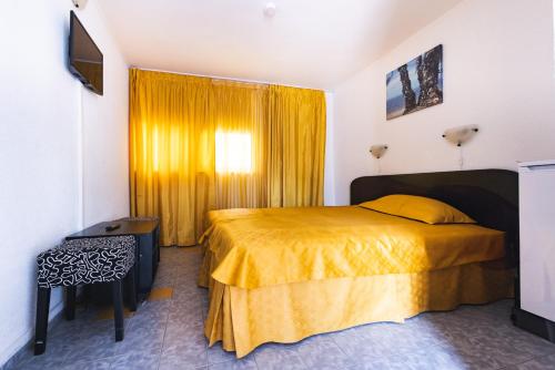 a bedroom with a bed with a yellow bedspread at Casa Galbena Paflora Saturn in Saturn
