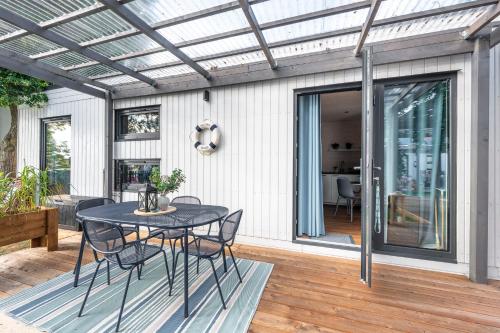 a patio with a table and chairs on a deck at Camping Molo Surf SPOT in Jastarnia