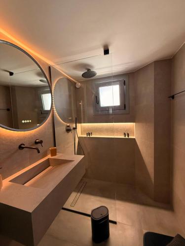 a bathroom with a large sink and a mirror at City Vibes Corinth in Korinthos