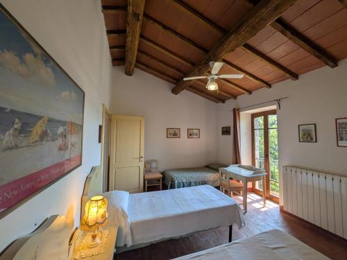 a room with a bed and a table and a window at Agriturismo Casa Greppo in San Venanzo