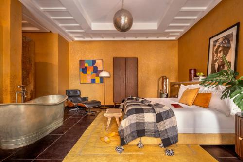 a hotel room with a bed and a bathtub at The Mellah Hotel in Marrakesh