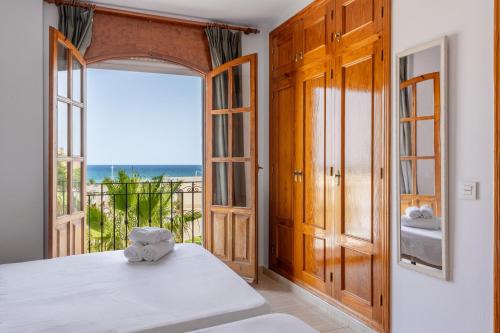 a bedroom with a bed and a view of the ocean at BF Rooms Garrucha in Garrucha