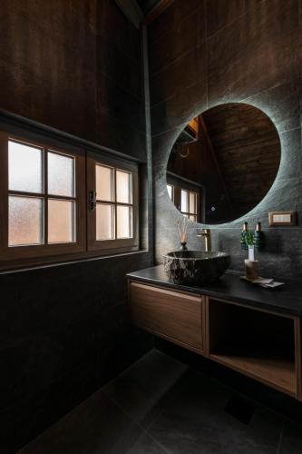 a bathroom with a sink and a mirror at Motherland Chalets in Žabljak
