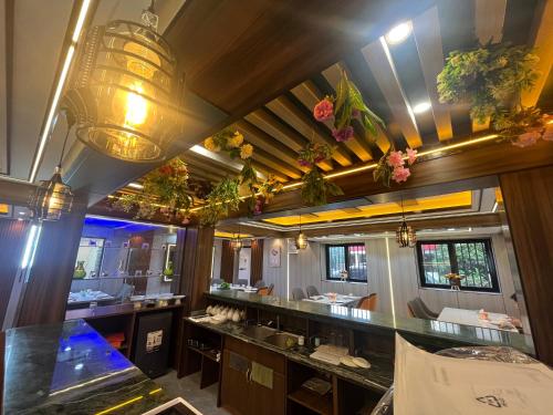 a bathroom with sinks and mirrors and flowers at HH Inn in Lagos