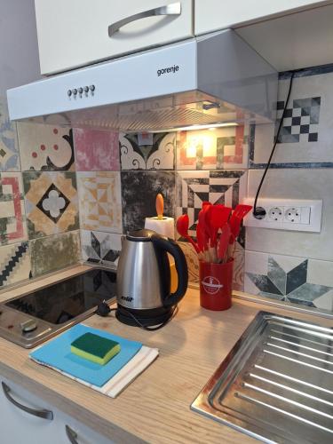a kitchen counter with a tea kettle on a stove at Villa Vino & Grad in Zagreb