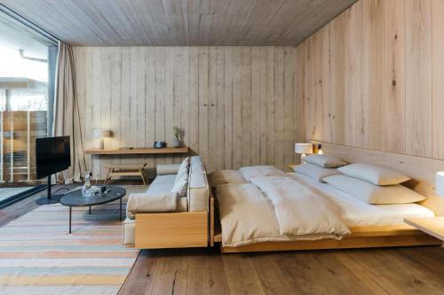 a bedroom with a large bed and a couch at Wiesergut in Saalbach-Hinterglemm