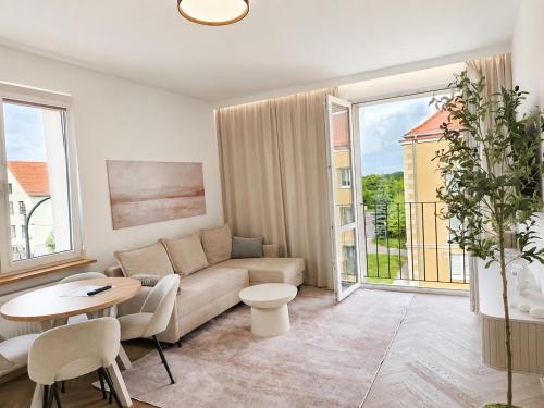 a living room with a couch and a table at Apartament Premium Orzysz in Orzysz