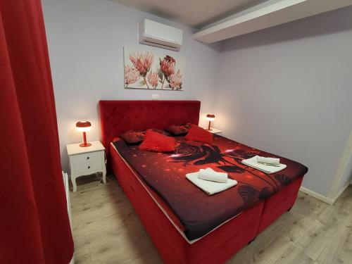 a red bed in a small room with two lamps on it at Villa Vino & Grad in Zagreb