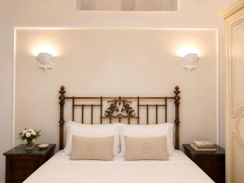 a bedroom with a bed with white sheets and pillows at Terrazza Rossetti in Vasto